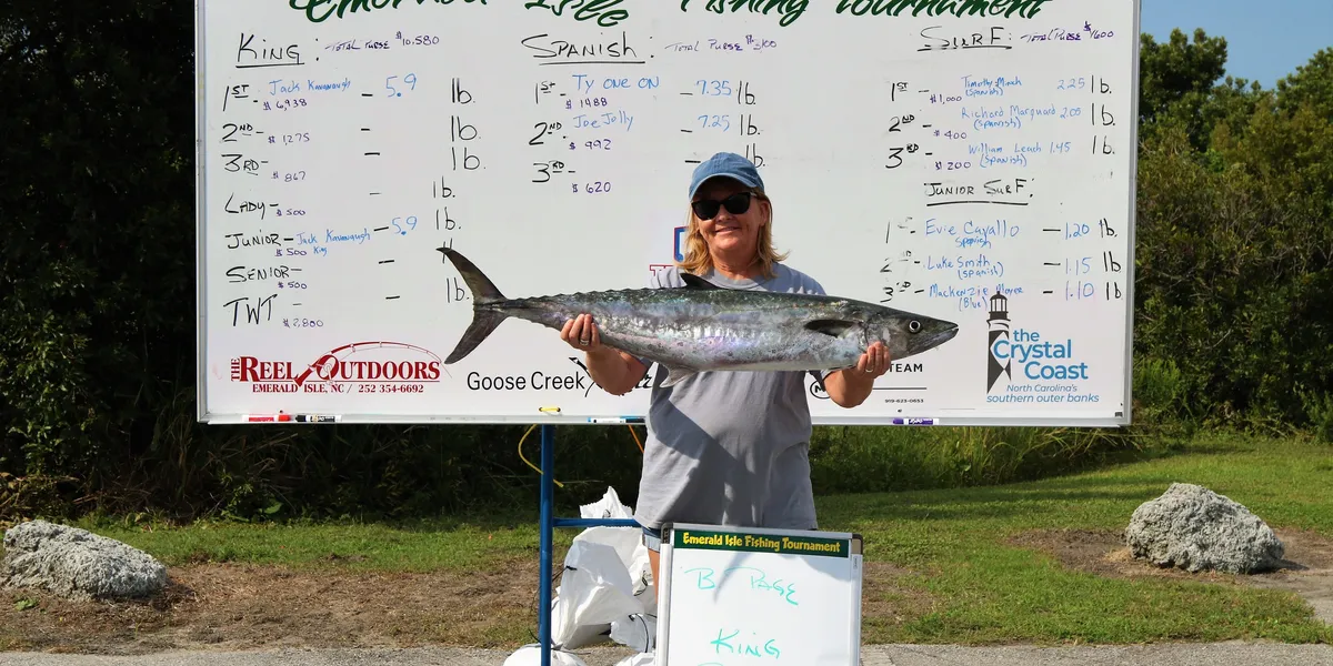 Photo of woman holding a large king mackerel.