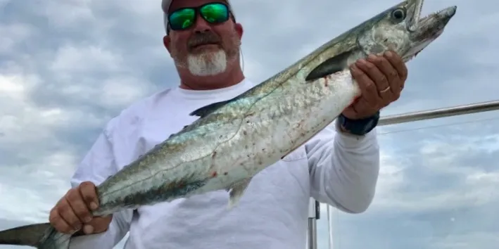 Man holding large king mackerel.
